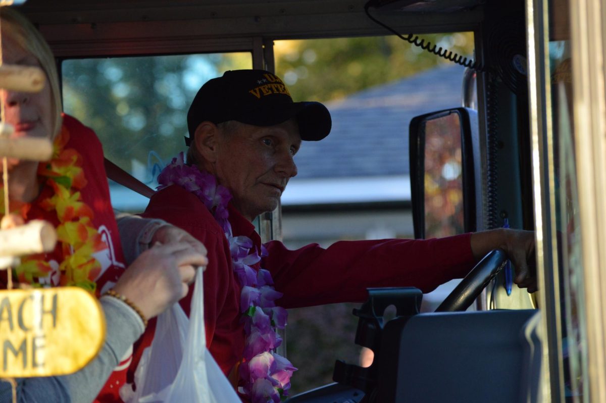 Mike McPherson, better known as Mr. Mike, drives the bus along the Homecoming Parade route to Grabinski Field on Friday, Oct. 18, 2024. 