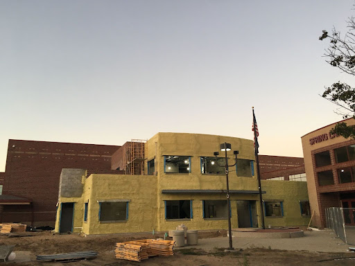 The front entrance is currently yellow, showing the insulation phase of the project that is expected to be completed for the 2025 school year.